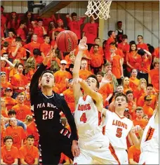  ?? Photograph by Randy Moll ?? Blackhawk senior Matt Thomas goes up for a shot but is blocked by Gravette Lion Chris Childress who attempts to grab the ball after blocking the shot during the matchup between the two teams in Lion Field House Friday, Jan. 20.