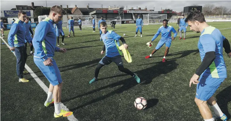  ?? — GETTY IMAGES ?? Sutton United players practise Thursday during media day ahead of their FA Cup fifth-round match Monday against Premier League giant Arsenal.