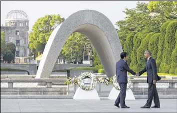  ?? CAROLYN KASTER / AP FILE ?? Japanese Prime Minister Shinzo Abe (left) will be the first leader of his country to go to the U.S. Naval base in Hawaii that Japan attacked in 1941, propelling the United States into World War II. He is seen here with President Obama at the Hiroshima...