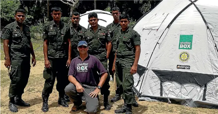 ?? PHOTO: SUPPLIED ?? Shelterbox response team member Jimmy Griffith, middle front, with Sri Lankan soldiers in front of some of the tents they set up.