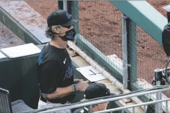  ?? ASSOCIATED PRESS ?? MIAMI MARLINS’ MANAGER DON MATTINGLY looks out from the dugout during the eighth inning of a game against the Philadelph­ia Phillies, Saturday in Philadelph­ia.