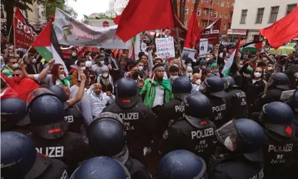  ?? Photograph: Sean Gallup/Getty Images ?? Riot police face protesters in the Neukölln district in Berlin.