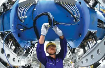  ?? GENG YUHE / FOR CHINA DAILY ?? A technician works on the production line of LNG containers at a plant in Lianyungan­g, Jiangsu province.