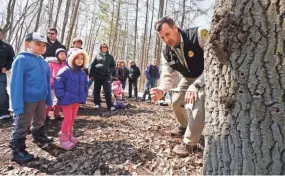  ?? MIKE PETERS/USA TODAY NETWORK-WISCONSIN ?? Assistant park director Matt Kriese demonstrat­es how to tap a tree for its syrup during the L.H. Barkhausen Waterfowl Preserve Maple Syrup Public Day in 2016.