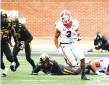  ?? AP PHOTO/ L. G. PATTERSON ?? Running back Zamir White (3) and the rest of the Georgia Bulldogs hope to be as motivated for a Peach Bowl date against Cincinnati as they were for their 49-14 thumping of Missouri on Dec. 12.