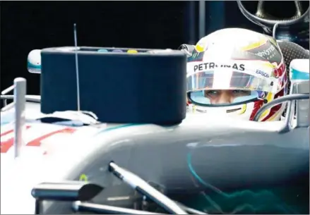  ?? YUYA SHINO/POOL/AFP ?? Mercedes driver Lewis Hamilton sits in his car before a qualifying session for the Japanese Grand Prix in Suzuka on October 8, 2016.