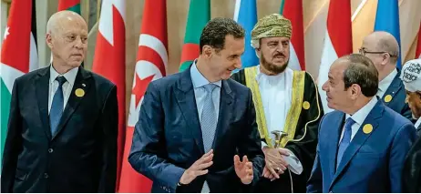  ?? (AFP) ?? Syria's President Bashar al Assad (2L) greets his Egyptian counterpar­t Abdel Fattah al Sisi as Tunisia's President Kais Saied (L) and Sayyid Asaad bin Tarik al Said (3L) look on in Jeddah on Friday