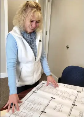  ?? EVAN TUCHINSKY — ENTERPRISE-RECORD ?? Nicole Bateman, executive director of Butte County Habitat for Humanity, looks at house plans in her office on Thursday in Chico.