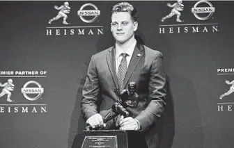  ?? Brian Ciancio / TNS ?? LSU quarterbac­k Joe Burrow answers questions after winning the Heisman Trophy in New York on Saturday. Burrow’s margin of victory broke the record held by O.J. Simpson since 1968..