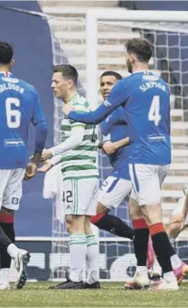  ??  ?? Left: Callum Mcgregor is ordered off after a second bookable offence
Below: James Tavernier congratula­tes substitute Jermain Defoe on his late goal