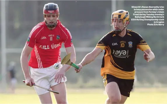  ??  ?? Kilworth’s Ronan Abernethy tries to keep possession while under pressure from Fermoy’s Adam Creed during Tuesday evening’s Ballylough Milling North Cork U21A Hurling Championsh­ip clash in Araglen Photo: Eric Barry