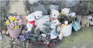  ??  ?? Poignant: Tributes which remain a year on at the slipway (right) at Buncrana pier