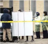  ?? ASHLEE REZIN GARCIA/SUN-TIMES ?? Department of Public Health workers set up a tent outside Vaughn Occupation­al H.S. for conducting health tests after a worker there tested positive for COVID-19 in March.