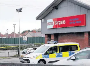  ??  ?? > The scene at Home Bargains in Rhyl the morning after Mark Mason was found dead