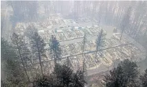  ?? AP ?? An aerial photo shows residences levelled by the wildfire in Paradise. Officials say the search for the missing and victim identifica­tion could take months.