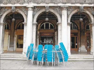  ?? Janna Brancolini For The Times ?? CAFES in Venice’s Piazza San Marco opted to stay closed Monday even though they were allowed to reopen as Italy eased lockdown restrictio­ns. Venice is expected to suffer huge tourism losses because of the pandemic.