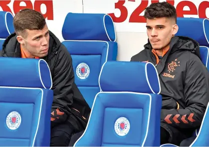  ??  ?? REINFORCEM­ENTS: January signings Florian Kamberi and Ianis Hagi take their seats on the Ibrox bench yesterday