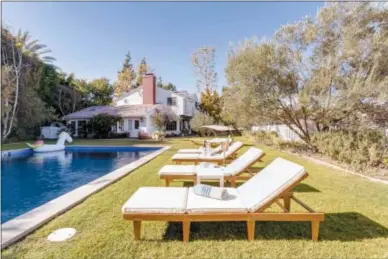  ?? AIRBNB PLUS VIA AP ?? A home in the Bel Air neighborho­od of Los Angeles. Peter Lorimer says it’s important to include a variety of amenities for guests. A At the home pictured here, the owner has provided beach toys and towels for guests to enjoy the pool.