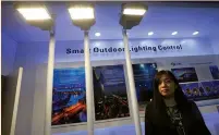  ?? (Bobby Yip/Reuters) ?? ROSE QIU, the marketing director of Zhejiang Fonda Technology, poses at a lighting fair in Hong Kong last week. ‘If you are those without special technology or products, you will die.’