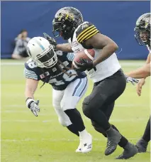  ?? JACK BOLAND/FILES ?? Toronto Argonauts linebacker Bear Woods, seen tackling Hamilton Tiger-Cats running back C.J. Gable RB earlier this season, says the Alouettes might have given him “a raw deal.”