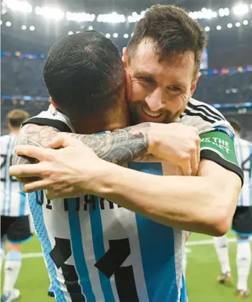  ?? DAN MULLAN/GETTY ?? Argentina’s Lionel Messi, right, celebrates a goal with teammate Angel Di Maria during Saturday’s match.