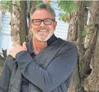  ?? TOM ERNSTING ?? Tom Ernsting, 60, lives part of the year at his home in South Haven, Michigan. He's worked to build a social media presence but has seen scammers steal his image to use in romance scams.