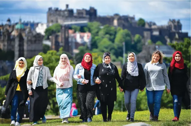  ?? Getty; images supplied ?? (Clockwise from main image) Sana’a AlFroukh (second from left) and other members of the Trojan Women Project in Edinburgh in 2019; A scene from a live performanc­e; Al-Froukh and Heba, another member of the Trojan Women Project.
