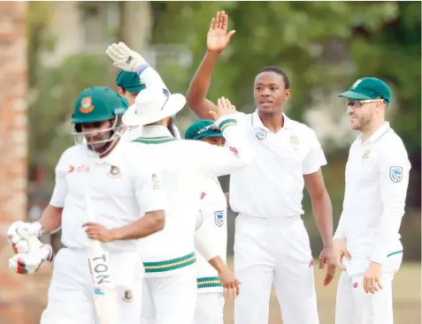  ?? — AFP ?? South Africa’s Kagiso Rabada (second right) celebrates the dismissal of Bangladesh batsman Imrul Kayes (left) during the second day of the first Test against Bangladesh in Potchefstr­oom, South Africa.