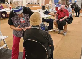  ?? BILL LACKEY / STAFF ?? Clark County residents get their COVID-19 vaccine shots at the Clark County Combined Health District’s vaccine distributi­on center at the Upper Valley Mall.