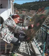  ?? REUTERS ?? In addition to boxing, 75-year-old Nancy Van Der Stracten paints at her home in southern Turkey despite suffering from Parkinson’s disease.