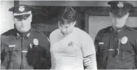  ?? Associated Press ?? ■ Peter Dushame, 33, of North Andover, Mass., center, is lead out of Nashua District Court in Nashua, N.H. on Oct. 3, 1989, after his arraignmen­t on a negligent homicide charge.