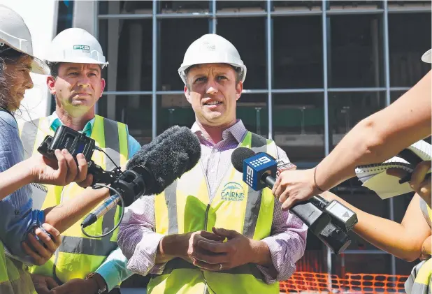  ?? Picture: BRENDAN RADKE ?? OFF COURSE: Environmen­t Minister Steven Miles, with Barron River MP Craig Crawford, faces the media at Cairns Aquarium yesterday.