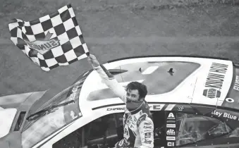  ?? DOUGLAS DEFELICE/USA TODAY SPORTS ?? Chase Elliott waves the checkered flag after winning the Go Bowling 235 on Aug. 18 at Daytona Internatio­nal Speedway.