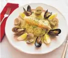  ??  ?? Red snapper in green sauce is supported by clams, mussels, asparagus and eggs.