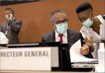  ?? Keystone / SALVATORE DI NOLFI photo via AP ?? Tedros Adhanom Ghebreyesu­s (left), Director General of the World Health Organizati­on, talks with a member of staff during the first day of the 75th World Health Assembly at the European headquarte­rs of the United Nations in Geneva, Switzerlan­d on Sunday.