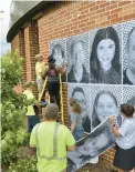  ?? VILLAGE OF FLOSSMOOR ?? Homewood-Flossmoor High School students and public works employees work together to install “Smiles Are Contagious” portraits outside of Flossmoor Village Hall.