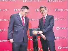  ??  ?? Zafrul Aziz (right) and Yong at the launch of Biz123, CIMB’s holistic business banking platform on Monday.