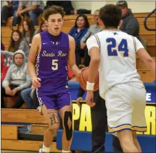  ?? JEANS PINEDA/Taos News ?? Marcos Chavez brings the ball up against the Panthers on Thursday (Dec. 22).