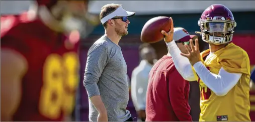  ?? LOS ANGELES TIMES/TNS 2022 ?? When coach Lincoln Riley (center) left Oklahoma to take over the football program at Southern California, then-sooners quarterbac­k Caleb Williams (right) decided he didn’t want to lose what he’d establishe­d with Riley, so he transferre­d to become a Trojan.