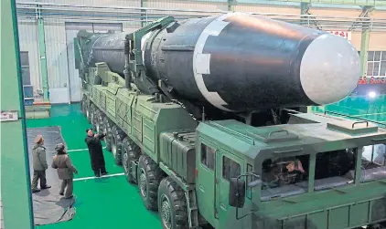  ?? AP ?? North Korean leader Kim Jong-un, third from left, is seen inspecting a Hwasong-15 interconti­nental ballistic missile in November last year.