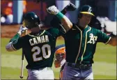  ?? MARCIO JOSE SANCHEZ — THE ASSOCIATED PRESS ?? Oakland Athletics’ Matt Olson, right, is congratula­ted by Mark Canha after hitting a solo home run against the Houston Astros during the fourth inning of Game 3 of a baseball American League Division Series in Los Angeles on Oct. 7, 2020.