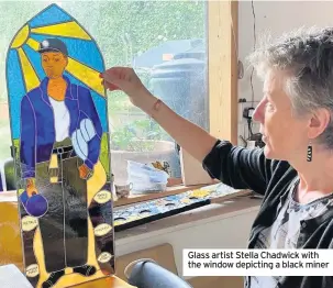  ??  ?? Glass artist Stella Chadwick with the window depicting a black miner