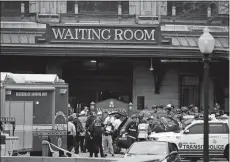  ?? JULIO CORTEZ/AP PHOTO ?? Emergency officials stand outside the Hoboken Terminal following a train crash Thursday in Hoboken, N.J.