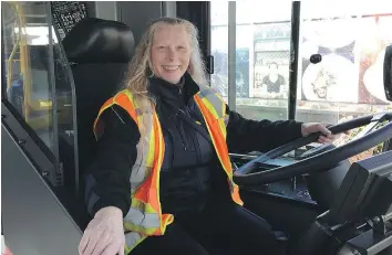  ?? JENNIFER SALTMAN/PNG ?? Driver Dee Cooke demonstrat­es the new barriers that will be installed on all new buses ordered by Coast Mountain Bus Company. Here she has the sliding partition open.