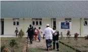  ??  ?? Khairul Ghazali, centre, leads students to a classroom at the Al-Hidayah Islamic Boarding School where they are taught about the goodness and mercy espoused in the Qur’an.