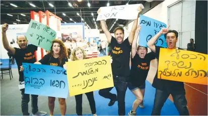  ??  ?? ACTIVISTS AT the WATEC exhibition at the Tel Aviv Convention Center yesterday call for implementi­ng Israeli water tech at home.