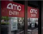  ?? Andrew Harrer/Bloomberg News ?? Temporaril­y closed signs hang on doors at an AMC movie theater in Washington, D.C.