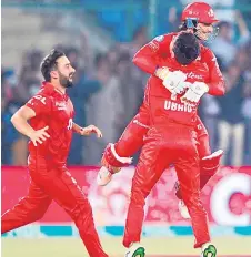  ?? — AFP photo ?? Islamabad United’s players celebrate their victory at the end of the Pakistan Super League (PSL) Twenty20 cricket final match between Islamabad United and Multan Sultans at the National Stadium in Karachi.