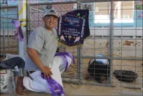  ??  ?? Calipatria 4-H club member Antonio Juarez and his pig Savage was named Supreme Champion earlier in the week of the California Mid-Winter Fair & Fiesta. Savage sold for $45 a pound at the auction Saturday. MARIO RENTERIA PHOTO