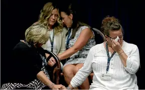  ?? AP ?? Victims of clergy sexual abuse, or their family members, react as Pennsylvan­ia Attorney General Josh Shapiro speaks during a news conference in Harrisburg.